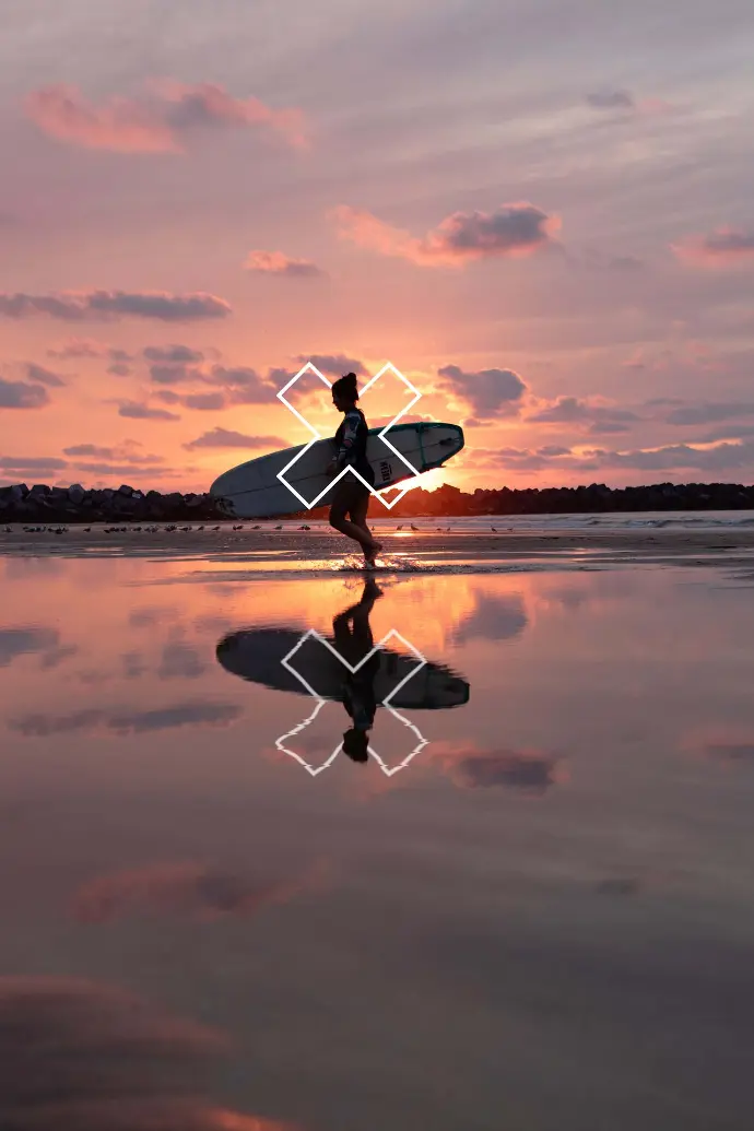 Silhouette of a woman carrying a surfboard, symbolizing the time and peace of mindgained through efficient systems